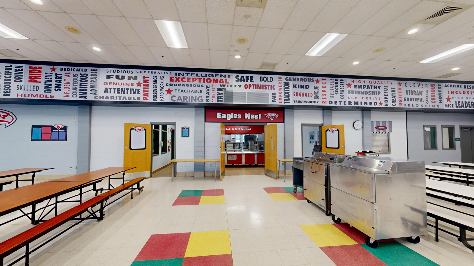 Eagles Nest cafeteria entrance below a character-word mural